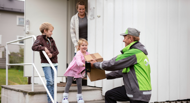 Family receiving delivery package from man